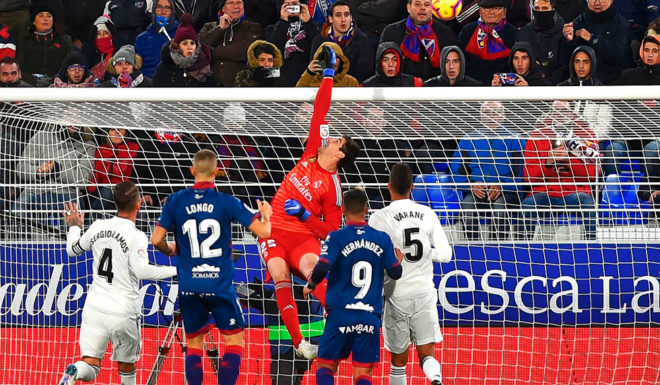Real Madrid's Belgian goalkeeper Thibaut Courtois hits the ball with his fist during the Spanish league football match between SD Huesca and Real Madrid CF at the El Alcoraz stadium in Huesca, on December 9, 2018. (Photo by ANDER GILLENEA / AFP) (Photo credit should read ANDER GILLENEA/AFP/Getty Images)