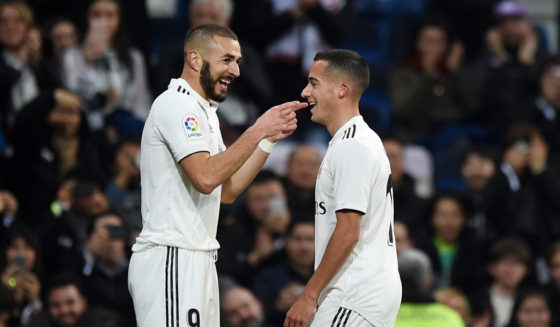 MADRID, SPAIN - DECEMBER 15: Karim Benzema of Real Madrid celebrates with teammate Lucas Vazquez after scoring his team's first goal during the La Liga match between Real Madrid CF and Rayo Vallecano de Madrid at Estadio Santiago Bernabeu on December 15, 2018 in Madrid, Spain. (Photo by Denis Doyle/Getty Images)