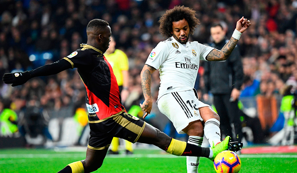 Rayo Vallecano's Peruvian defender Luis Advincula (L) vies with Real Madrid's Brazilian defender Marcelo during the Spanish League football match between Real Madrid and Rayo Vallecano at the Santiago Bernabeu stadium in Madrid on December 15, 2018. (Photo by GABRIEL BOUYS / AFP) (Photo credit should read GABRIEL BOUYS/AFP/Getty Images)