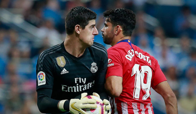 MADRID, SPAIN - SEPTEMBER 29: Goalkeeper Thibaut Courtois (L) of Real Madrid CF clashes with Diego Costa (R) of Atletico de Madrid during the La Liga match between Real Madrid CF and Club Atletico de Madrid at Estadio Santiago Bernabeu on September 29, 2018 in Madrid, Spain. (Photo by Gonzalo Arroyo Moreno/Getty Images)