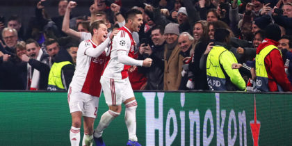 AMSTERDAM, NETHERLANDS - DECEMBER 12: Dusan Tadic of Ajax celebrates with team mates after scoring his sides second goal during the UEFA Champions League Group E match between Ajax and FC Bayern Muenchen at Johan Cruyff Arena on December 12, 2018 in Amsterdam, Netherlands. (Photo by Dean Mouhtaropoulos/Getty Images)