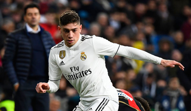 Real Madrid's Uruguayan midfielder Federico Valverde (R) dribbles the ball during the Spanish League football match between Real Madrid and Rayo Vallecano at the Santiago Bernabeu stadium in Madrid on December 15, 2018. (Photo by GABRIEL BOUYS / AFP) (Photo credit should read GABRIEL BOUYS/AFP/Getty Images)