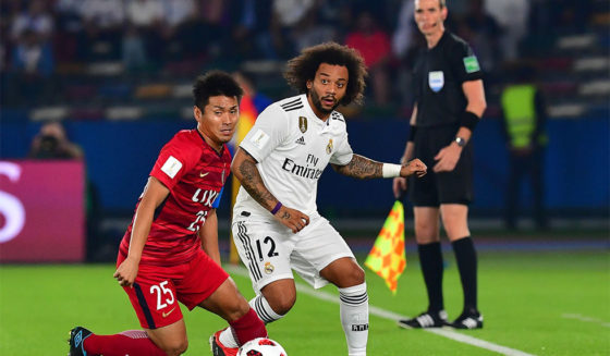 Kashima Antler's midfielder Yasushi Endo (L) marks Real Madrid's Brazilian defender Marcelo during the semi final football match of the FIFA Club World Cup 2018 tournament between Japan's Kashima Antlers and Spain's Real Madrid at the Zayed Sports City Stadium in Abu Dhabi, the capital of the United Arab Emirates, on December 19, 2018. (Photo by Giuseppe CACACE / AFP) (Photo credit should read GIUSEPPE CACACE/AFP/Getty Images)