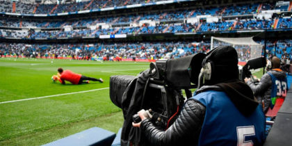 A TV crew member films the warm-up session ahead of the Spanish league football match between Real Madrid CF and Club Atletico de Madrid at the Santiago Bernabeu stadium in Madrid on April 8, 2018. / AFP PHOTO / GABRIEL BOUYS (Photo credit should read GABRIEL BOUYS/AFP/Getty Images)