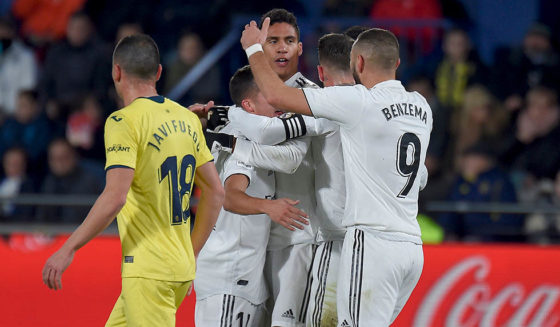 Real Madrid's French defender Raphael Varane (C) celebrates with teammates after scoring a goal during the Spanish League football match between Villarreal CF and Real Madrid CF at La Ceramica stadium in Vila-real on January 3, 2019. (Photo by JOSE JORDAN / AFP) (Photo credit should read JOSE JORDAN/AFP/Getty Images)