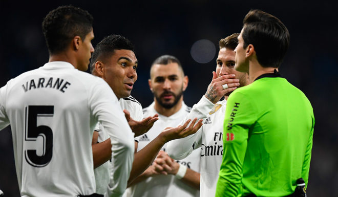 Real Madrid's Brazilian midfielder Casemiro (2L) and teammates protest to Spanish referee Jose Luis Munuera during the Spanish League football match between Real Madrid CF and Real Sociedad at the Santiago Bernabeu stadium in Madrid on January 6, 2019. (Photo by GABRIEL BOUYS / AFP) (Photo credit should read GABRIEL BOUYS/AFP/Getty Images)