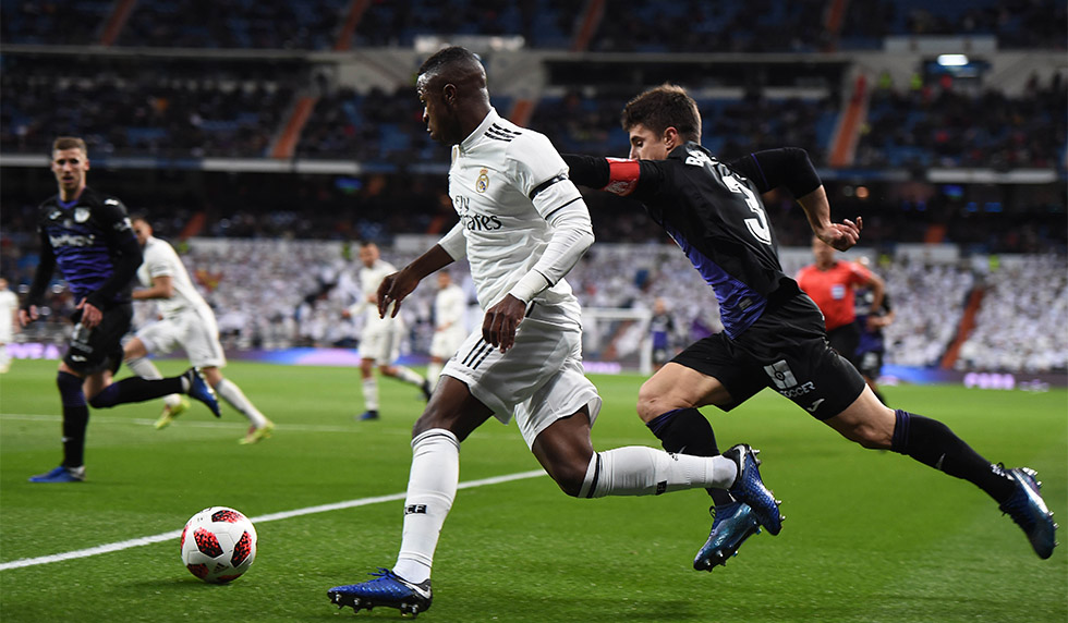 MADRID, SPAIN - JANUARY 09: Vinicius Junior of Real Madrid CF gets past Unai Bustinza of CD Leganes during the Copa del Rey Round of 16 match between Real Madrid CF and CD Leganes at estadio Santiago Bernabeu on January 09, 2019 in Madrid, Spain. (Photo by Denis Doyle/Getty Images)