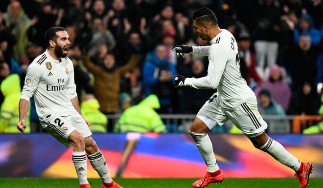 Real Madrid's Brazilian midfielder Casemiro (R) celebrates with Real Madrid's Spanish defender Dani Carvajal after scoring a goal during the Spanish League football match between Real Madrid and Sevilla at the Santiago Bernabeu stadium in Madrid on January 19, 2019. (Photo by PIERRE-PHILIPPE MARCOU / AFP) (Photo credit should read PIERRE-PHILIPPE MARCOU/AFP/Getty Images)
