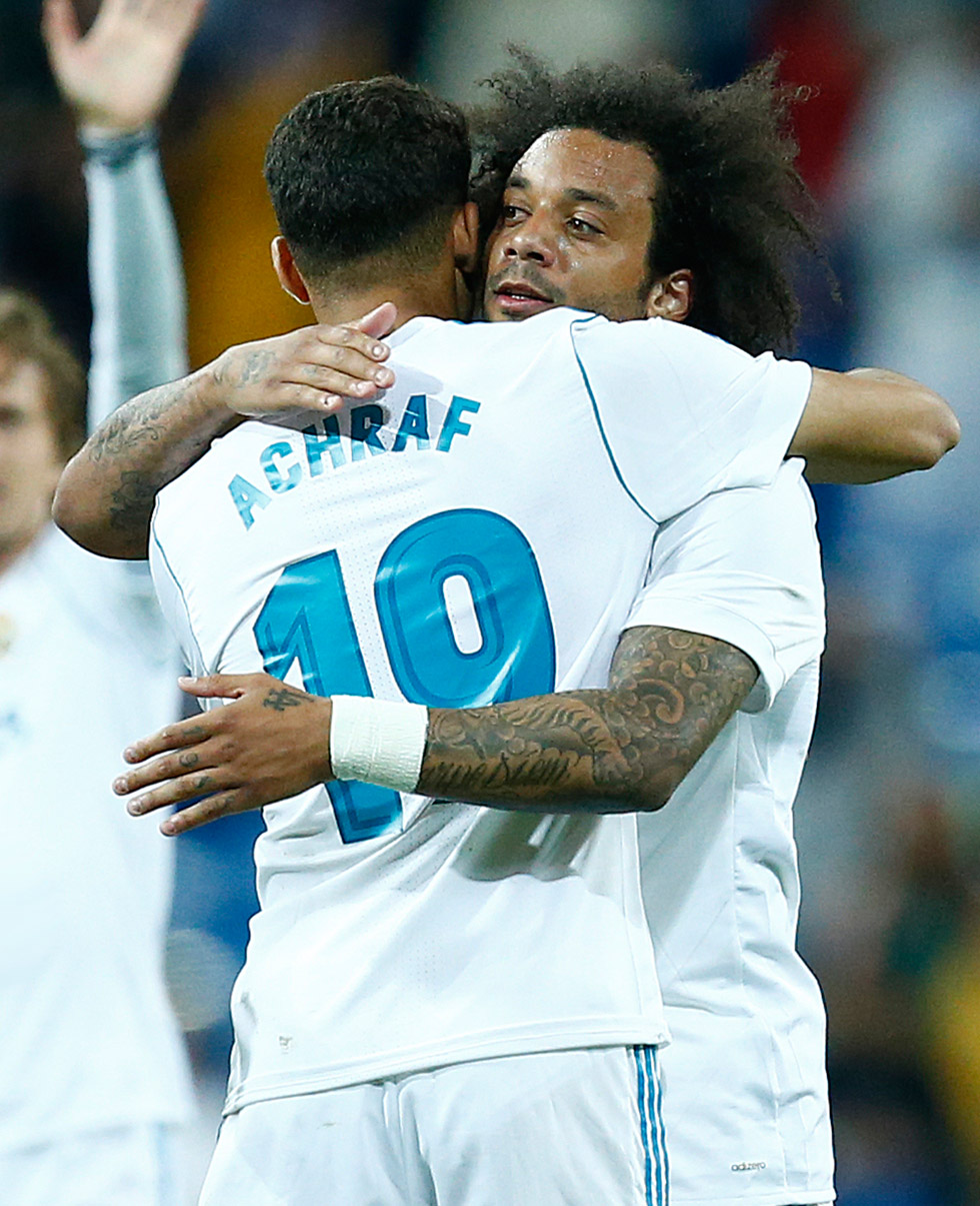 Real Madrid's Spanish-Moroccan defender Achraf Hakimi (2R) celebrates a goal with Real Madrid's Brazilian defender Marcelo (R) during the Spanish league football match between Real Madrid and Celta Vigo at the Santiago Bernabeu Stadium in Madrid on May 12, 2018. (Photo by Benjamin CREMEL / AFP) (Photo credit should read BENJAMIN CREMEL/AFP/Getty Images)