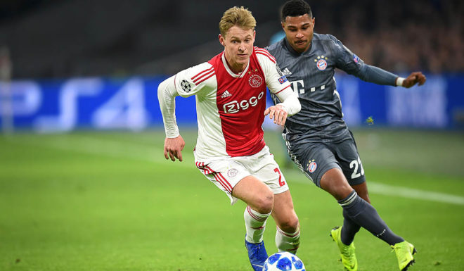 Ajax's Dutch midfielder Frenkie de Jong (L) vies with Bayern Munich's German forward Serge Gnabry during the UEFA Champions League Group E football match between AFC Ajax and FC Bayern Munchen at the Johan Cruyff Arena in Amsterdam on December 12, 2018. (Photo by JOHN THYS / AFP) (Photo credit should read JOHN THYS/AFP/Getty Images)