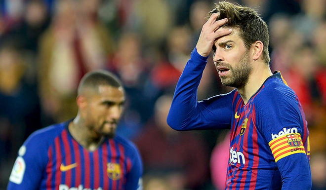 Barcelona's Spanish defender Gerard Pique (R) reacts to Sevilla's goal during the Spanish Copa del Rey (King's Cup) quarter-final first leg football match between Sevilla FC and FC Barcelona at the Ramon Sanchez Pizjuan stadium in Seville on January 23, 2019. (Photo by CRISTINA QUICLER / AFP) (Photo credit should read CRISTINA QUICLER/AFP/Getty Images)