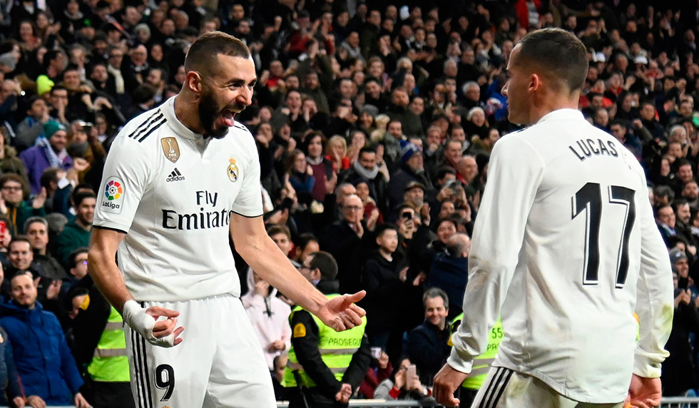 Real Madrid's French forward Karim Benzema (L) celebrates with Real Madrid's Spanish midfielder Lucas Vazquez after scoring during the Spanish Copa del Rey (King's Cup) quarter-final first leg football match between Real Madrid CF and Girona FC at the Santiago Bernabeu stadium in Madrid on January 24, 2019. (Photo by JAVIER SORIANO / AFP) (Photo credit should read JAVIER SORIANO/AFP/Getty Images)