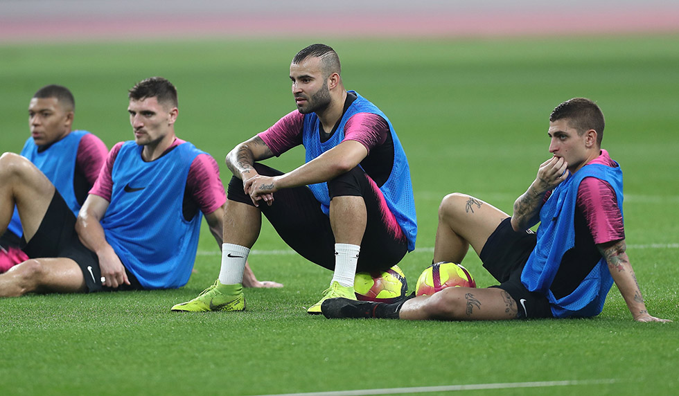 (From L) Paris Saint-Germain's French forward Kylian Mbappe, Paris Saint-Germain's Belgian defender Thomas Meunier, Paris Saint-Germain's Spanish forward Jese Rodriguez and Paris Saint-Germain's Italian midfielder Marco Verratti sit watching during their winter training camp at the Khalifa International Stadium in the Qatari capital Doha on January 15, 2019. (Photo by Karim JAAFAR / AFP) (Photo credit should read KARIM JAAFAR/AFP/Getty Images)