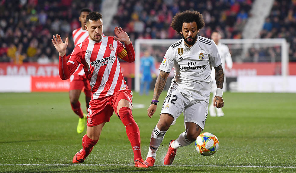 GIRONA, SPAIN - JANUARY 31: Alex Granell of Girona and Marcelo of Real Madrid in action during the Copa del Quarter Final match between Girona and Real Madrid at Montilivi Stadium on January 31, 2019 in Girona, Spain. (Photo by David Ramos/Getty Images )