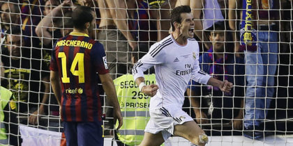 Real Madrid's Welsh forward Gareth Bale (R) celebrates after scoring during the Spanish Copa del Rey (King's Cup) final "Clasico" football match FC Barcelona vs Real Madrid CF at the Mestalla stadium in Valencia on April 16, 2014. AFP PHOTO / CESAR MANSO (Photo credit should read CESAR MANSO/AFP/Getty Images)