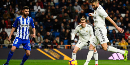 Real Madrid's French forward Karim Benzema (R) shoots to score the opening goal during the Spanish league football match Real Madrid CF against Club Deportivo Alaves at the Santiago Bernabeu stadium in Madrid on February 3, 2019. (Photo by GABRIEL BOUYS / AFP) (Photo credit should read GABRIEL BOUYS/AFP/Getty Images)