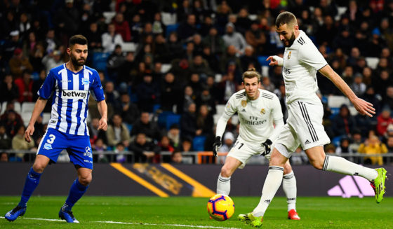 Real Madrid's French forward Karim Benzema (R) shoots to score the opening goal during the Spanish league football match Real Madrid CF against Club Deportivo Alaves at the Santiago Bernabeu stadium in Madrid on February 3, 2019. (Photo by GABRIEL BOUYS / AFP) (Photo credit should read GABRIEL BOUYS/AFP/Getty Images)