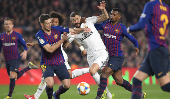 Barcelona's French defender Clement Lenglet (L) and Barcelona's Portuguese defender Nelson Semedo (R) vie for the ball with Real Madrid's French forward Karim Benzema (C) during the Spanish Copa del Rey (King's Cup) semi-final first leg football match between FC Barcelona and Real Madrid CF at the Camp Nou stadium in Barcelona on February 6, 2019. (Photo by LLUIS GENE / AFP) (Photo credit should read LLUIS GENE/AFP/Getty Images)