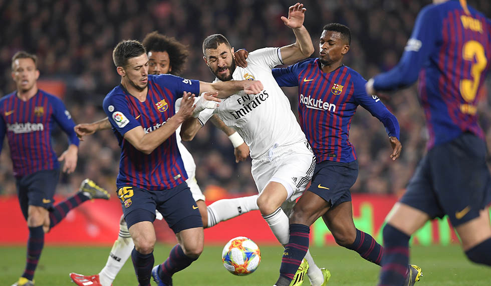 Barcelona's French defender Clement Lenglet (L) and Barcelona's Portuguese defender Nelson Semedo (R) vie for the ball with Real Madrid's French forward Karim Benzema (C) during the Spanish Copa del Rey (King's Cup) semi-final first leg football match between FC Barcelona and Real Madrid CF at the Camp Nou stadium in Barcelona on February 6, 2019. (Photo by LLUIS GENE / AFP) (Photo credit should read LLUIS GENE/AFP/Getty Images)