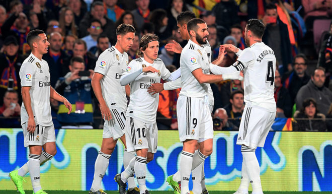 Real Madrid's Spanish midfielder Lucas Vazquez (L) celebrates with teammates after scoring during the Spanish Copa del Rey (King's Cup) semi-final first leg football match between FC Barcelona and Real Madrid CF at the Camp Nou stadium in Barcelona on February 6, 2019. (Photo by LLUIS GENE / AFP) / The erroneous mention[s] appearing in the metadata of this photo by LLUIS GENE has been modified in AFP systems in the following manner: [Real Madrid's Spanish midfielder Lucas Vazquez] instead of [Real Madrid's French forward Karim Benzema]. Please immediately remove the erroneous mention[s] from all your online services and delete it (them) from your servers. If you have been authorized by AFP to distribute it (them) to third parties, please ensure that the same actions are carried out by them. Failure to promptly comply with these instructions will entail liability on your part for any continued or post notification usage. Therefore we thank you very much for all your attention and prompt action. We are sorry for the inconvenience this notification may cause and remain at your disposal for any further information you may require. (Photo credit should read LLUIS GENE/AFP/Getty Images)