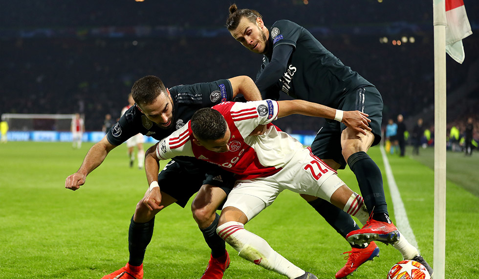 AMSTERDAM, NETHERLANDS - FEBRUARY 13: Hakim Ziyech of Ajax is challenged by Daniel Carvajal of Real Madrid and Gareth Bale of Real Madrid during the UEFA Champions League Round of 16 First Leg match between Ajax and Real Madrid at Johan Cruyff Arena on February 13, 2019 in Amsterdam, Netherlands. (Photo by Lars Baron/Getty Images)