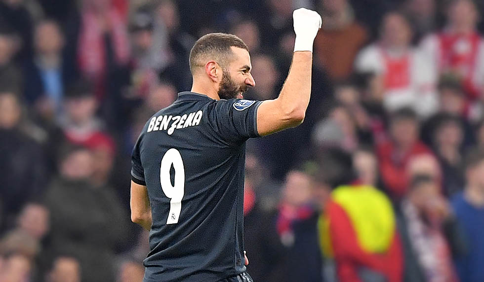 Real Madrid's French forward Karim Benzema celebrates after scoring during the UEFA Champions league round of 16 first leg football match between Ajax Amsterdam and Real Madrid at the Johan Cruijff ArenA on February 13, 2019. (Photo by EMMANUEL DUNAND / AFP) (Photo credit should read EMMANUEL DUNAND/AFP/Getty Images)