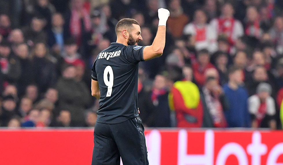 Real Madrid's French forward Karim Benzema celebrates after scoring during the UEFA Champions league round of 16 first leg football match between Ajax Amsterdam and Real Madrid at the Johan Cruijff ArenA on February 13, 2019. (Photo by EMMANUEL DUNAND / AFP) (Photo credit should read EMMANUEL DUNAND/AFP/Getty Images