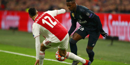 AMSTERDAM, NETHERLANDS - FEBRUARY 13: Vinicius Junior of Real Madrid is challenged by Noussair Mazraoui of Ajax during the UEFA Champions League Round of 16 First Leg match between Ajax and Real Madrid at Johan Cruyff Arena on February 13, 2019 in Amsterdam, Netherlands. (Photo by Dean Mouhtaropoulos/Getty Images)