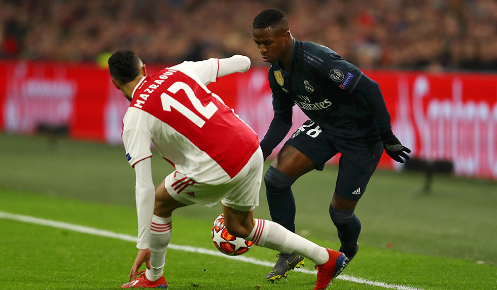 AMSTERDAM, NETHERLANDS - FEBRUARY 13: Vinicius Junior of Real Madrid is challenged by Noussair Mazraoui of Ajax during the UEFA Champions League Round of 16 First Leg match between Ajax and Real Madrid at Johan Cruyff Arena on February 13, 2019 in Amsterdam, Netherlands. (Photo by Dean Mouhtaropoulos/Getty Images)