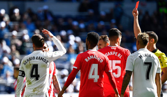 Real Madrid's Spanish defender Sergio Ramos (L) reacts as he is shown a red card by Spanish referee Guillermo Cuadra Fernandez (R) during the Spanish League football match between Real Madrid and Girona at the Santiago Bernabeu stadium in Madrid on February 17, 2019. (Photo by GABRIEL BOUYS / AFP) (Photo credit should read GABRIEL BOUYS/AFP/Getty Images)