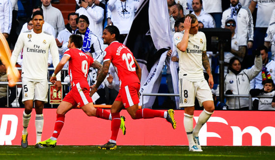 Real Madrid's French defender Raphael Varane (L) and Real Madrid's German midfielder Toni Kroos (C) react as Girona's Spanish midfielder Portu (2ndL) celebrates with teammates after scoring his team's second goal during the Spanish League football match between Real Madrid and Girona at the Santiago Bernabeu stadium in Madrid on February 17, 2019. (Photo by GABRIEL BOUYS / AFP) (Photo credit should read GABRIEL BOUYS/AFP/Getty Images)