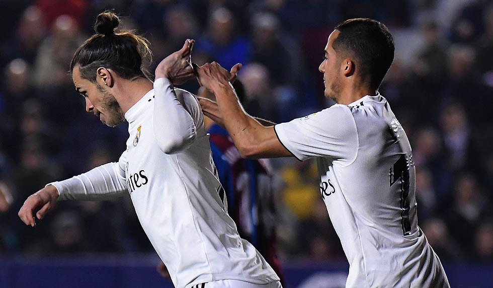 Real Madrid's Welsh forward Gareth Bale (L) celebrates with Real Madrid's Spanish midfielder Lucas Vazquez after scoring a goal during the Spanish league football match between Levante UD and Real Madrid CF at the Ciutat de Valencia stadium in Valencia on February 24, 2019. (Photo by JOSE JORDAN / AFP) (Photo credit should read JOSE JORDAN/AFP/Getty Images)