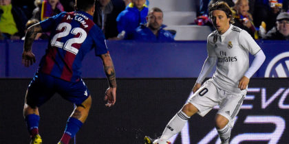 Levante's Spanish defender Antonio Luna (L) challenges Real Madrid's Croatian midfielder Luka Modric during the Spanish league football match between Levante UD and Real Madrid CF at the Ciutat de Valencia stadium in Valencia on February 24, 2019. (Photo by JOSE JORDAN / AFP) (Photo credit should read JOSE JORDAN/AFP/Getty Images)