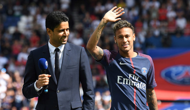 Paris Saint-Germain's Brazilian forward Neymar (C), flanked by Paris Saint Germain's (PSG) Qatari president Nasser Al-Khelaifi (L), waves to the crowd during his presentation to the fans at the Parc des Princes stadium in Paris, on August 5, 2017.