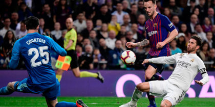 Barcelona's Croatian midfielder Ivan Rakitic (C) scores a goal past Real Madrid's Spanish defender Sergio Ramos (R) and Real Madrid's Belgian goalkeeper Thibaut Courtois (L) during the Spanish league football match between Real Madrid CF and FC Barcelona at the Santiago Bernabeu stadium in Madrid on March 2, 2019. (Photo by JAVIER SORIANO / AFP) (Photo credit should read JAVIER SORIANO/AFP/Getty Images)