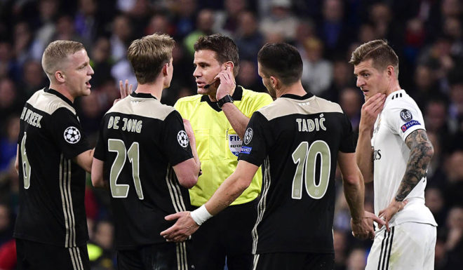 (FromL) Ajax's Dutch midfielder Donny van de Beek, Ajax's Dutch midfielder Frenkie de Jong, Ajax's Serbian forward Dusan Tadic and Real Madrid's German midfielder Toni Kroos argue with German referee Felix Brych during the UEFA Champions League round of 16 second leg football match between Real Madrid CF and Ajax at the Santiago Bernabeu stadium in Madrid on March 5, 2019. (Photo by JAVIER SORIANO / AFP) (Photo credit should read JAVIER SORIANO/AFP/Getty Images)