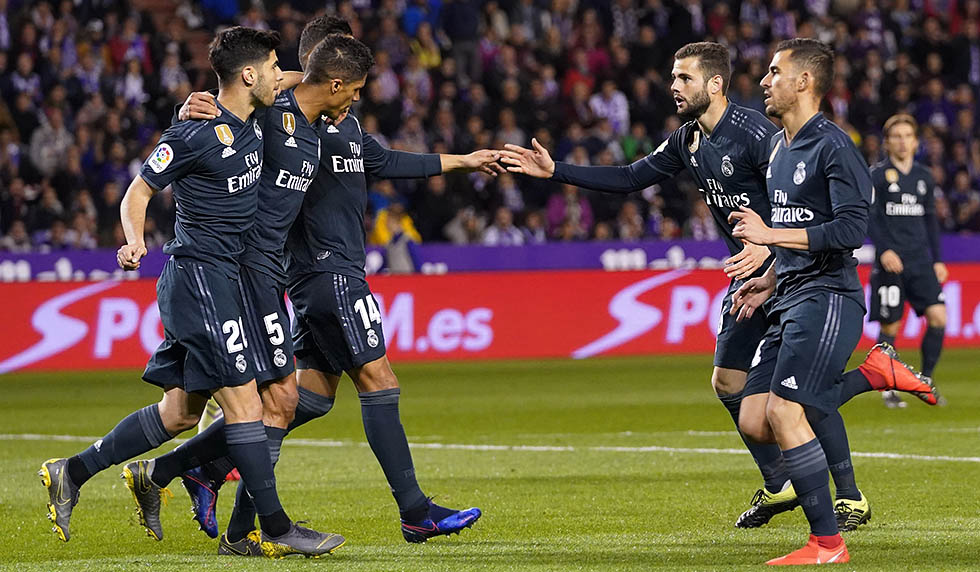 Real Madrid's French defender Raphael Varane (2L) celebrates his goal with teammates during the Spanish league football match between Real Valladolid FC and Real Madrid CF at the Jose Zorrilla stadium in Valladolid on March 10, 2019. (Photo by CESAR MANSO / AFP) (Photo credit should read CESAR MANSO/AFP/Getty Images)