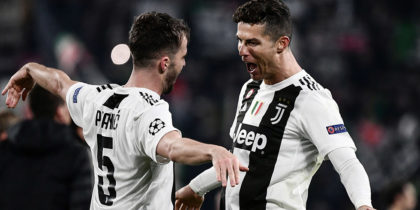 Juventus' Bosnian midfielder Miralem Pjanic (L) embraces Juventus' Portuguese forward Cristiano Ronaldo at the end of the UEFA Champions League round of 16 second-leg football match Juventus vs Atletico Madrid on March 12, 2019 at the Juventus stadium in Turin. (Photo by Marco BERTORELLO / AFP) (Photo credit should read MARCO BERTORELLO/AFP/Getty Images)