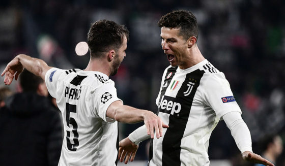 Juventus' Bosnian midfielder Miralem Pjanic (L) embraces Juventus' Portuguese forward Cristiano Ronaldo at the end of the UEFA Champions League round of 16 second-leg football match Juventus vs Atletico Madrid on March 12, 2019 at the Juventus stadium in Turin. (Photo by Marco BERTORELLO / AFP) (Photo credit should read MARCO BERTORELLO/AFP/Getty Images)