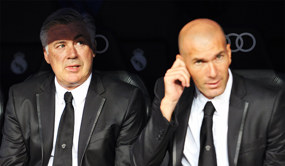 Real Madrid's Italian coach Carlo Ancelotti (L) and Real Madrid's first team Director Zinedine Zidane (R) look on before the Spanish league football match Real Madrid CF vs Real Betis at the Santiago Bernabeu stadium in Madrid on August 18, 2012. AFP PHOTO / GERARD JULIEN (Photo credit should read GERARD JULIEN/AFP/Getty Images)