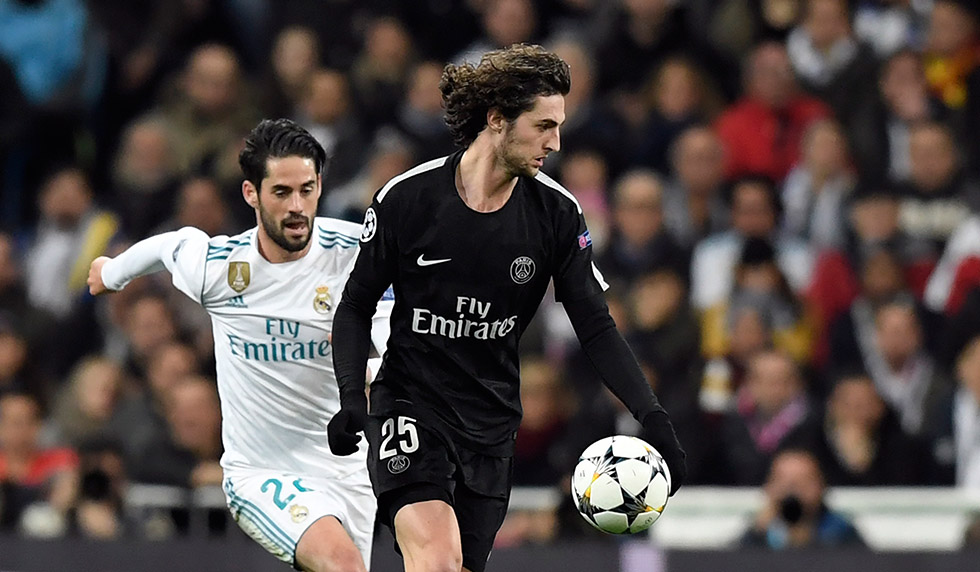 Real Madrid's Spanish midfielder Isco (L) vies with Paris Saint-Germain's French midfielder Adrien Rabiot (R) during the UEFA Champions League round of sixteen first leg football match Real Madrid CF against Paris Saint-Germain (PSG) at the Santiago Bernabeu stadium in Madrid on February 14, 2018. / AFP PHOTO / GABRIEL BOUYS (Photo credit should read GABRIEL BOUYS/AFP/Getty Images)