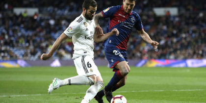 MADRID, SPAIN - MARCH 31: Nacho of Real Madrid goes past Damian Musto of Huesca during the La Liga match between Real Madrid CF and SD Huesca at Estadio Santiago Bernabeu on March 31, 2019 in Madrid, Spain. (Photo by Gonzalo Arroyo Moreno/Getty Images)