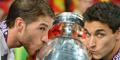 Spanish defender Sergio Ramos (L) and midfielder Jesus Navas kiss the trophy after winning the Euro 2012 football championships final match Spain vs Italy on July 1, 2012 at the Olympic Stadium in Kiev. AFP PHOTO / GABRIEL BOUYS (Photo credit should read GABRIEL BOUYS/AFP/GettyImages)