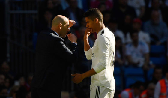 Real Madrid's French coach Zinedine Zidane talks to Real Madrid's French defender Raphael Varane during the Spanish league football match between Real Madrid CF and RC Celta de Vigo at the Santiago Bernabeu stadium in Madrid on March 16, 2019. (Photo by GABRIEL BOUYS / AFP) (Photo credit should read GABRIEL BOUYS/AFP/Getty Images)