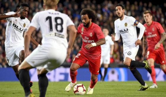 Real Madrid's Brazilian defender Marcelo (C) vies with Valencia's French midfielder Geoffrey Kondogbia (L) during the Spanish league football match between Valencia CF and Real Madrid CF at the Mestalla stadium in Valencia on April 3, 2019. (Photo by JOSE JORDAN / AFP) (Photo credit should read JOSE JORDAN/AFP/Getty Images)