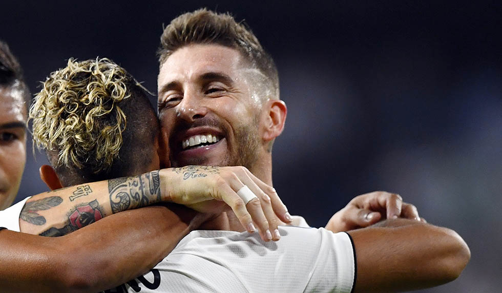 TOPSHOT - Real Madrid's Spanish-Dominican forward Mariano (2R) celebrates his goal with Real Madrid's Spanish defender Sergio Ramos (R) during the UEFA Champions League group G football match between Real Madrid CF and AS Roma at the Santiago Bernabeu stadium in Madrid on September 19, 2018. (Photo by GABRIEL BOUYS / AFP) (Photo credit should read GABRIEL BOUYS/AFP/Getty Images)