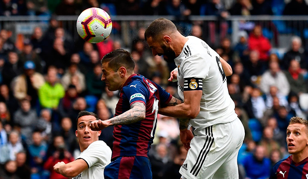 Real Madrid's French forward Karim Benzema (R) scores a goal during the Spanish league football match between Real Madrid CF and SD Eibar at the Santiago Bernabeu stadium in Madrid on April 6, 2019. (Photo by GABRIEL BOUYS / AFP) (Photo credit should read GABRIEL BOUYS/AFP/Getty Images)