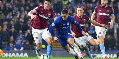 Chelsea's Belgian midfielder Eden Hazard (C) runs past West Ham United's Paraguayan defender Fabián Balbuena (L) and West Ham United's English midfielder Mark Noble (2nd R) during the English Premier League football match between Chelsea and West Ham United at Stamford Bridge in London on April 8, 2019. (Photo by OLLY GREENWOOD / AFP) / RESTRICTED TO EDITORIAL USE. No use with unauthorized audio, video, data, fixture lists, club/league logos or 'live' services. Online in-match use limited to 120 images. An additional 40 images may be used in extra time. No video emulation. Social media in-match use limited to 120 images. An additional 40 images may be used in extra time. No use in betting publications, games or single club/league/player publications. / (Photo credit should read OLLY GREENWOOD/AFP/Getty Images)