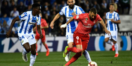 Real Madrid's French forward Karim Benzema (R) controls the ball next to Leganes' Nigerian defender Kenneth Omeruo during the Spanish league football match between Club Deportivo Leganes SAD and Real Madrid CF at the Estadio Municipal Butarque in Leganes on April 15, 2019. (Photo by PIERRE-PHILIPPE MARCOU / AFP) (Photo credit should read PIERRE-PHILIPPE MARCOU/AFP/Getty Images)