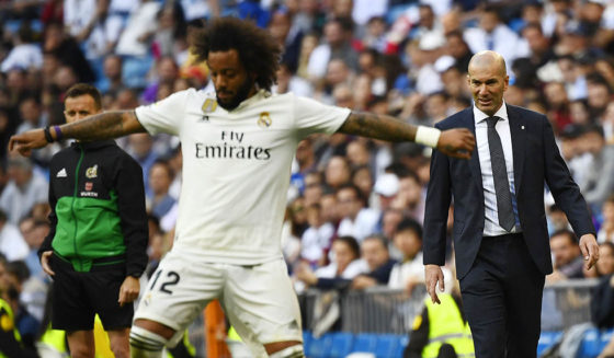 Real Madrid's French coach Zinedine Zidane (R) looks at Real Madrid's Brazilian defender Marcelo controlling the ball during the Spanish league football match between Real Madrid CF and RC Celta de Vigo at the Santiago Bernabeu stadium in Madrid on March 16, 2019. (Photo by GABRIEL BOUYS / AFP) (Photo credit should read GABRIEL BOUYS/AFP/Getty Images)